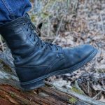 One man wear tactical boots stand on the wood