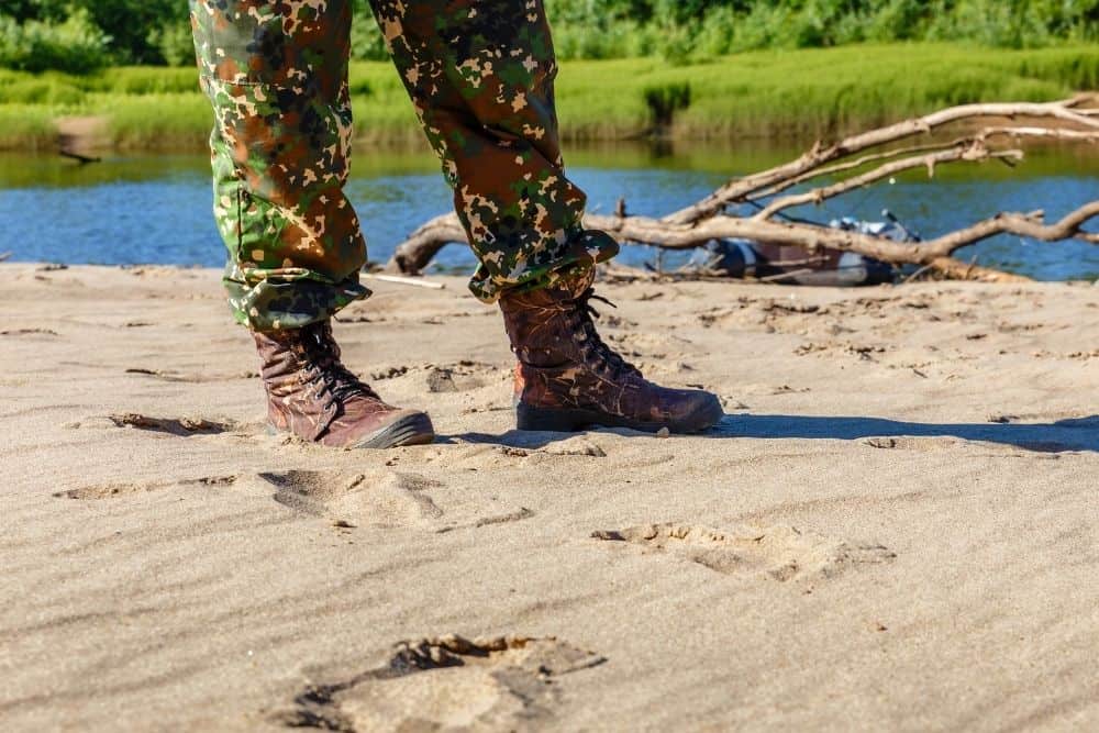 man wearing breathable tactical boots on sandy terrain