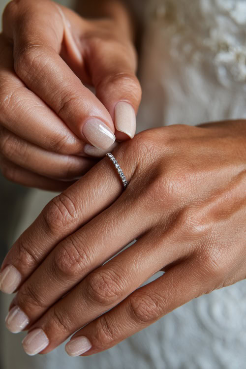 Elegant hand adjusting bridal bracelet, short square nails in sheer ivory with chrome shimmer overlay and tiny rhinestones near the cuticle