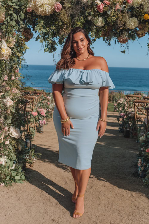 Stylish plus-size woman wearing a light blue off-the-shoulder midi dress with a ruffled neckline, gold accessories, and low heels, posing near a romantic coastal wedding setup 